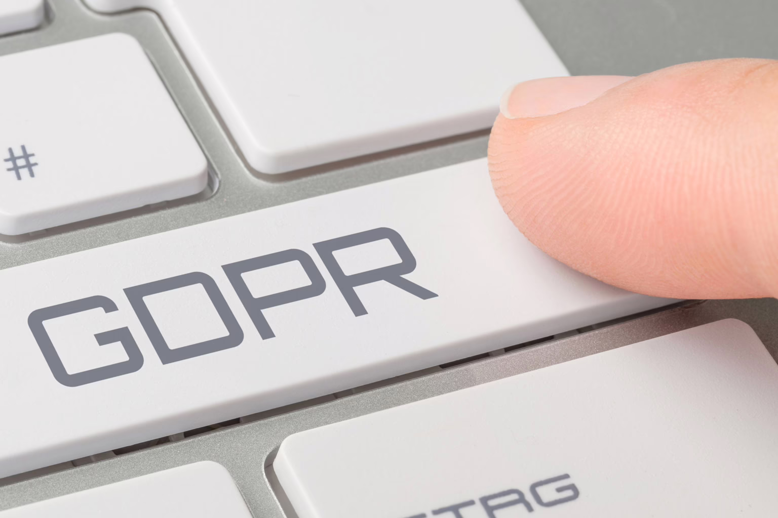 Finger pressing GDPR key on keyboard illustrating gdpr data flow and compliance.